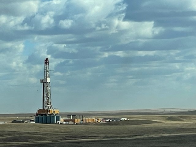 Oil field landscape with storage tanks