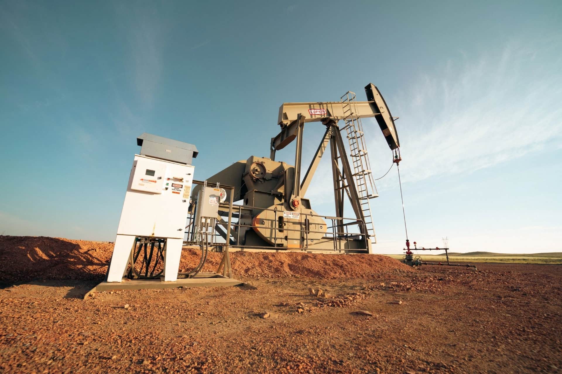 A pump jack is shown in the desert.