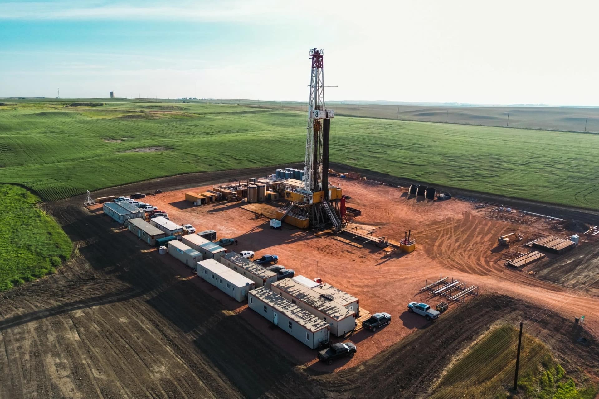 A drilling rig in the middle of an open field.